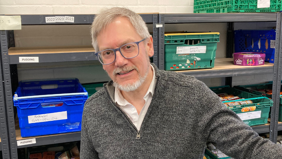 Steve Clay at Cambridge City Foodbank with boxes of donated food