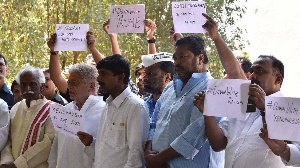 Some mourners held signs denouncing racism and xenophobia