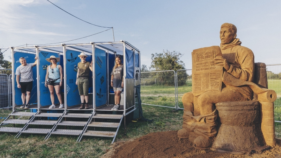 Four environmentally friendly loos next to the sculpture