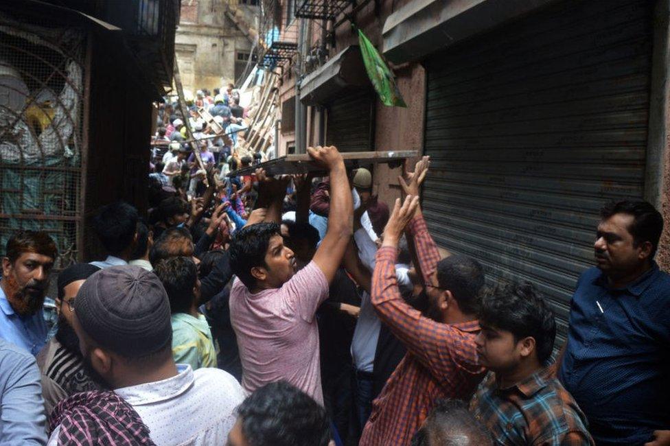 Fire Brigade and NDRF personnel carry out rescue works after the collapse of the four-storey Kesarbai building at Dongri on July 16, 2019 in Mumbai.