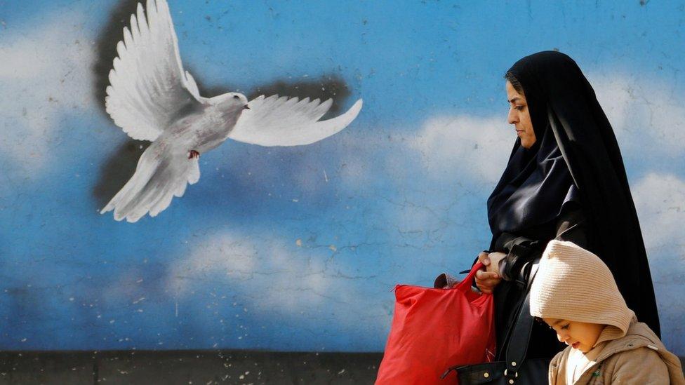 An Iranian woman and child walk in a street in Tehran, Iran, 16 January 2016