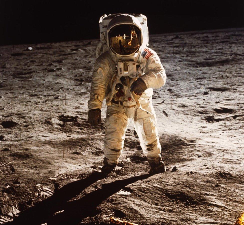 Astronaut Buzz Aldrin walks on the surface of the Moon near the leg of the Lunar Module (LM) "Eagle" during the Apollo 11 mission, 20 July 1969