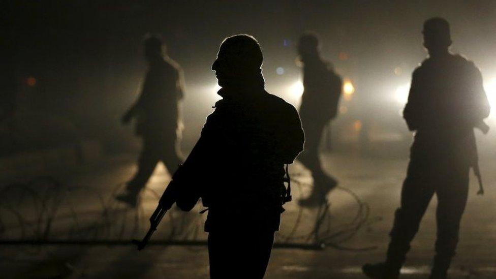 Afghan policeman at the site of the blast in Kabul's diplomatic zone