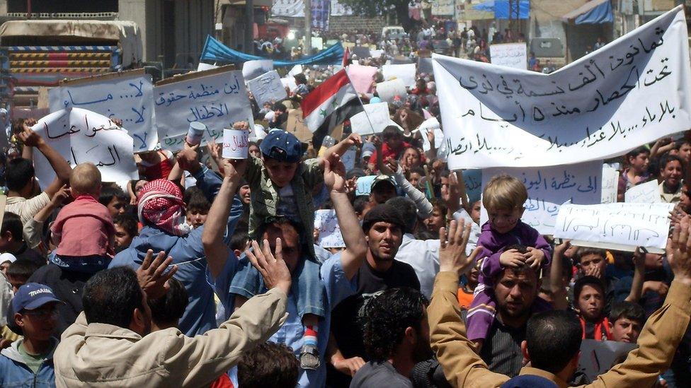 Syrian anti-government protesters near the southern town of Deraa, in April, 2011