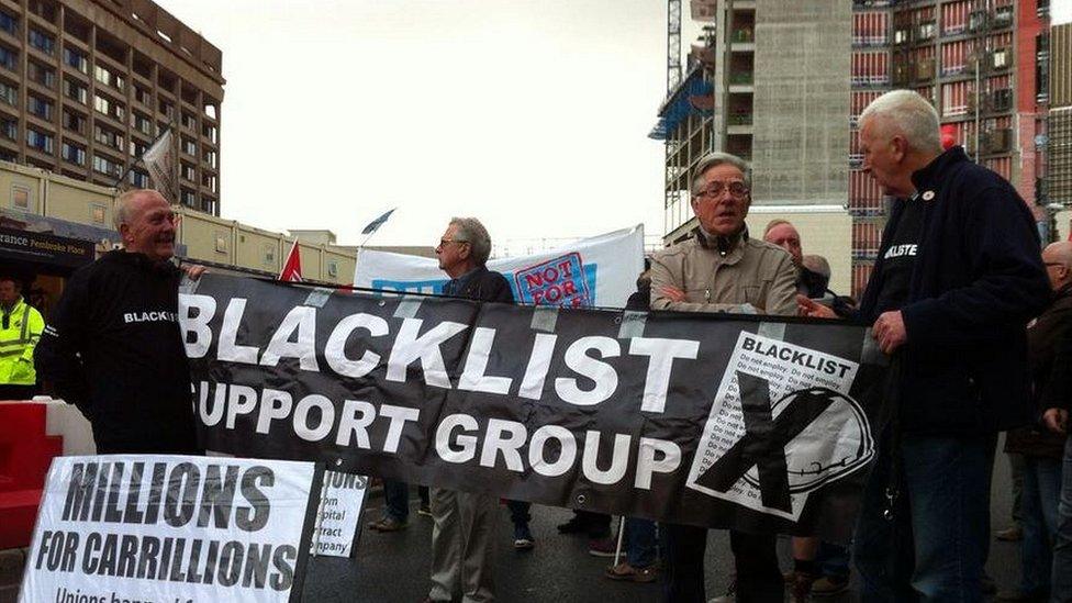 demonstrators with banner