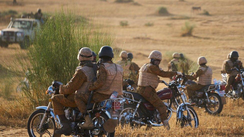 A group of soldiers of the Burkina Faso Army patrols a rural area during a joint operation with the French Army in the Soum region in northern Burkina Faso on November 10, 2019.