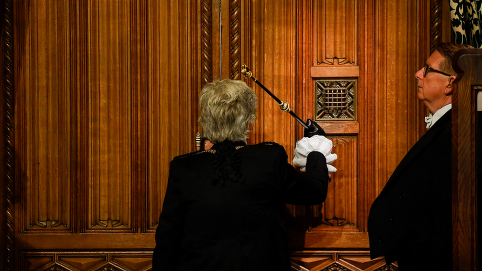 Sarah Clarke, Black Rod, bangs on the doors to the house of commons at the beginning of the State Opening ceremony of Parliament at the Palace of Westminster on May 10, 2022