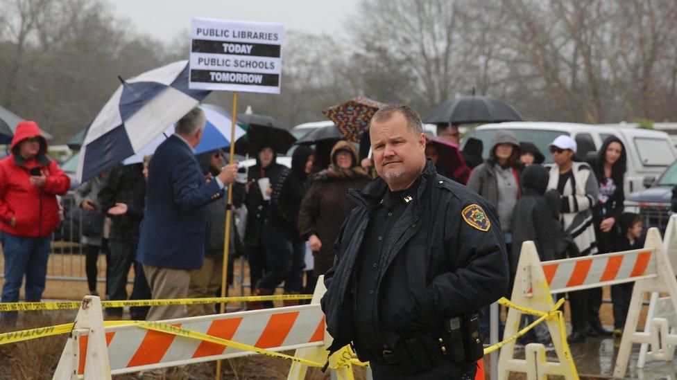 A police officer and a group of protesters