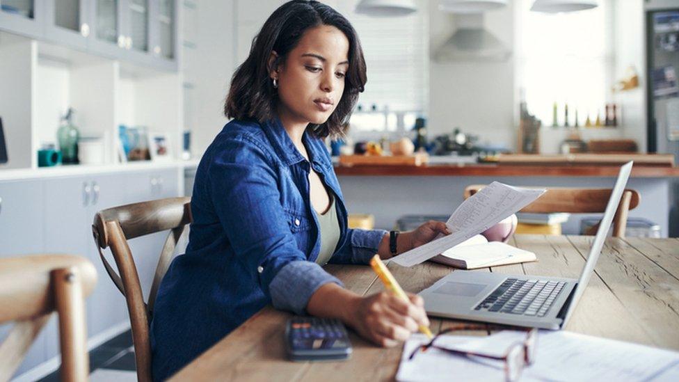 Woman with computer and calculator