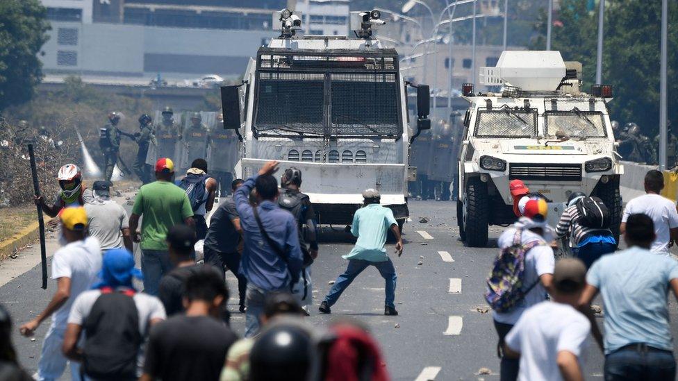 Protesters clash with police in Caracas on 30 April