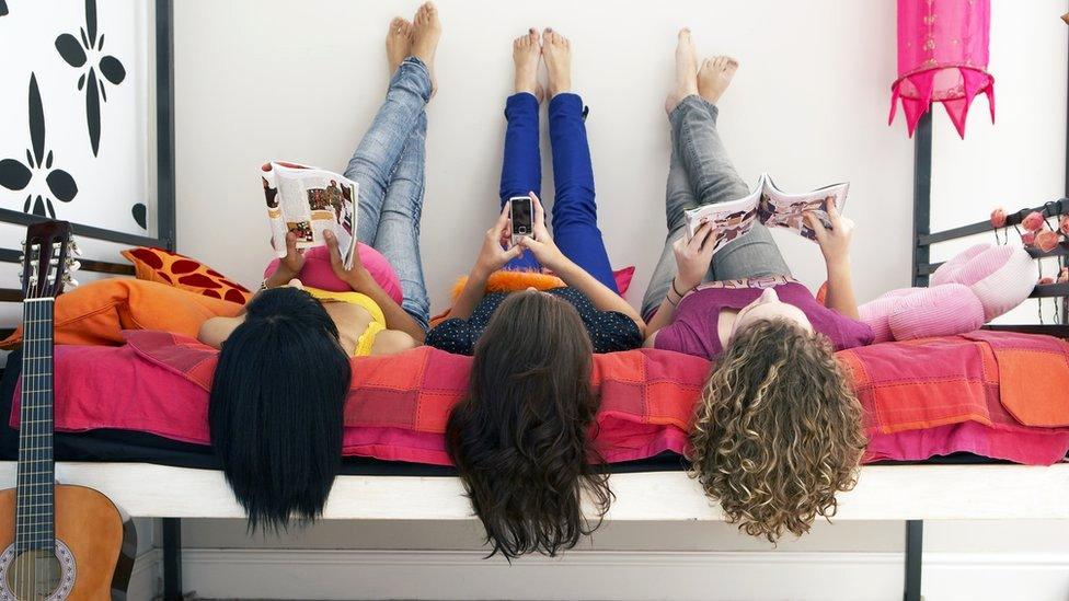 Girls reading magazines