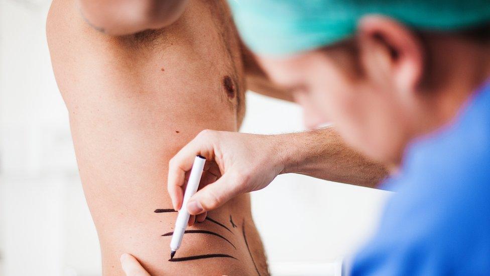 Doctor marking patient with pen