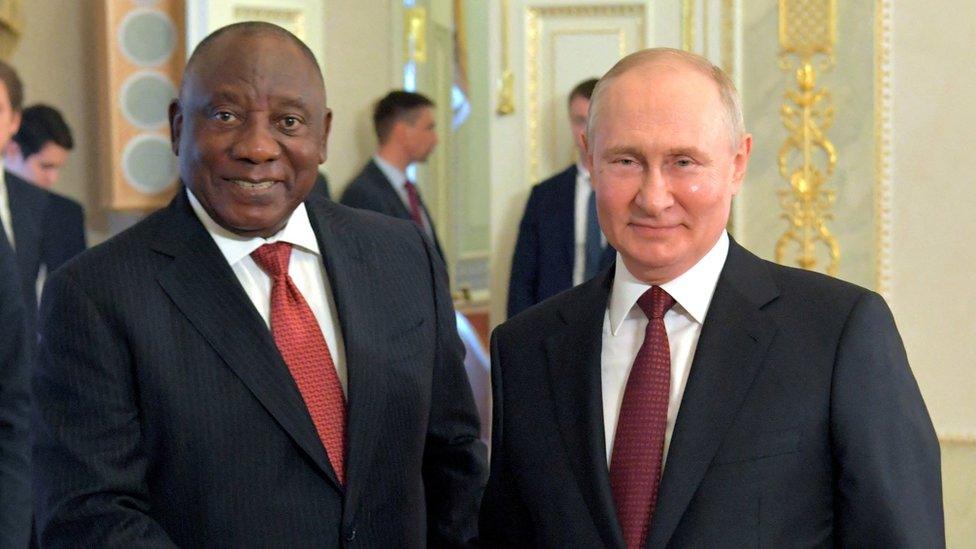 Russian President Vladimir Putin shakes hands with South African President Cyril Ramaphosa