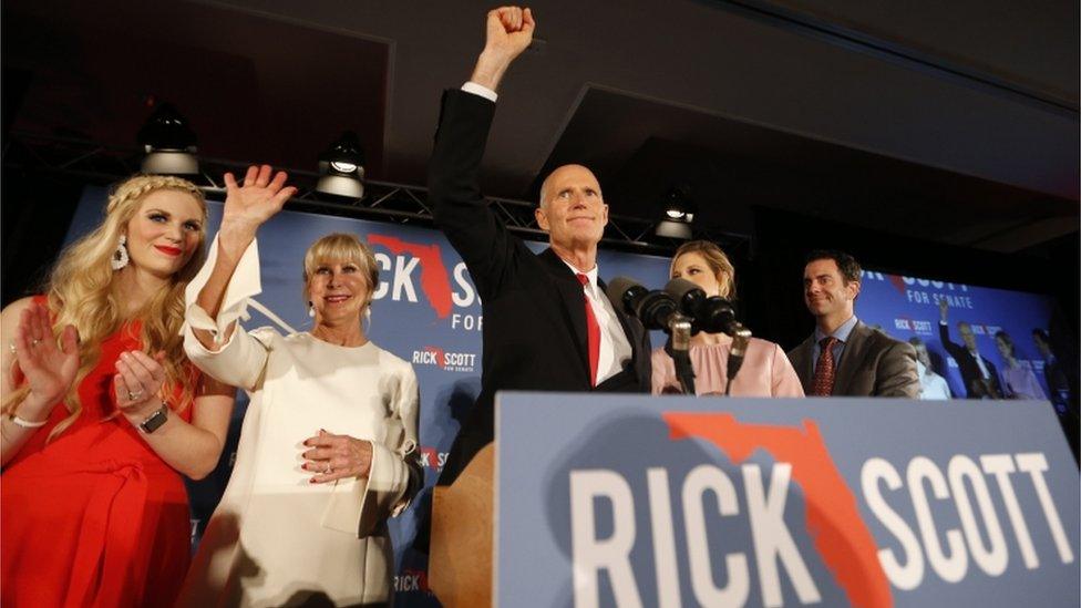 Republican U.S. Senate candidate Rick Scott steps up to the stage with his wife Ann at his midterm election night party