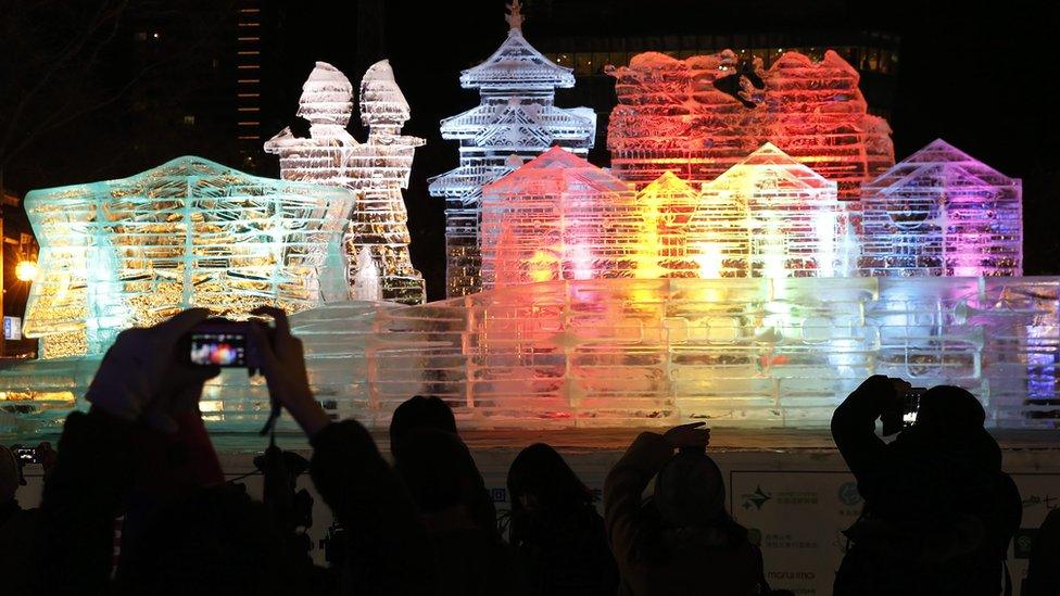 A snow sculpture lit up at night time