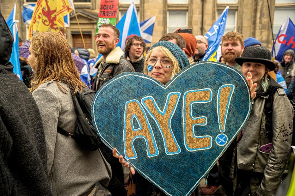 Woman with banner saying "aye"