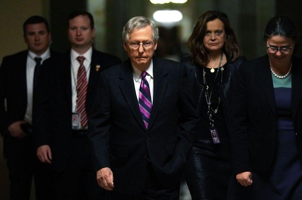 Republican Senate Leader Mitch McConnell walks to the floor after the bill's passage