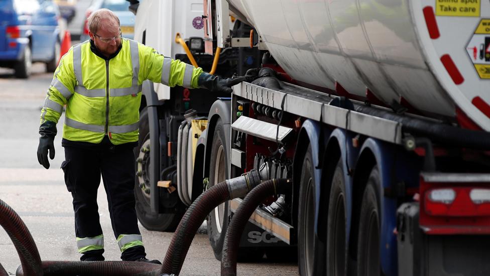 A delivery driver refills the pumps at a petrol station in Flamstead, St Albans, 29 September 2021