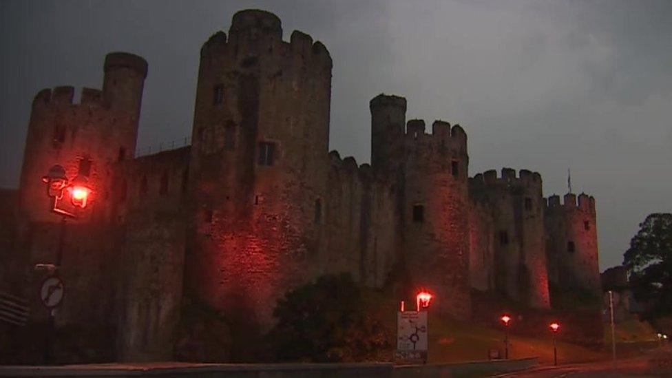 Conwy castle lit up red