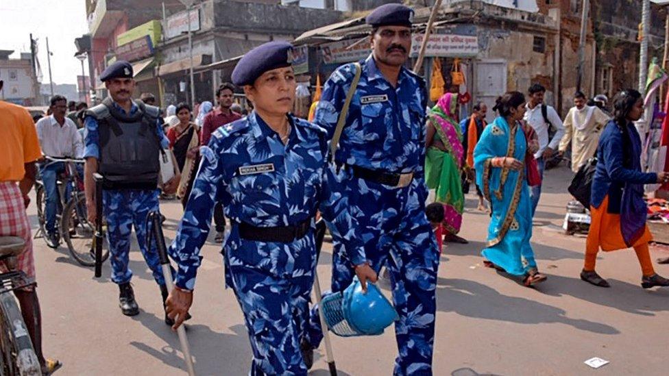 Rapid Action Force (RPF) personnel patrol on a street in Ayodhya on November 8, 2019