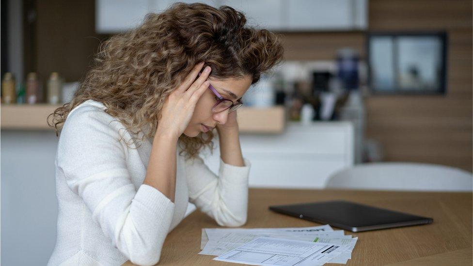 Woman looks at bill stock image