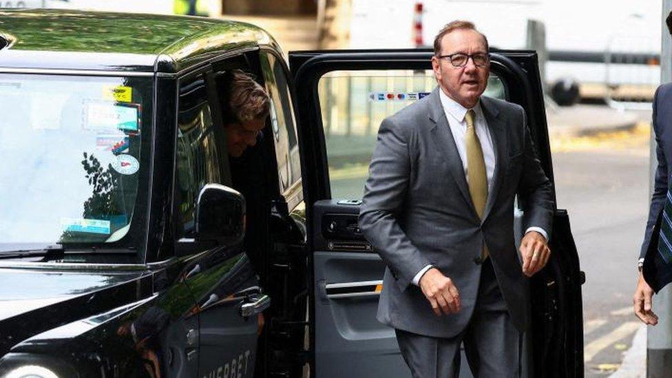 Kevin Spacey getting out of a taxi outside court