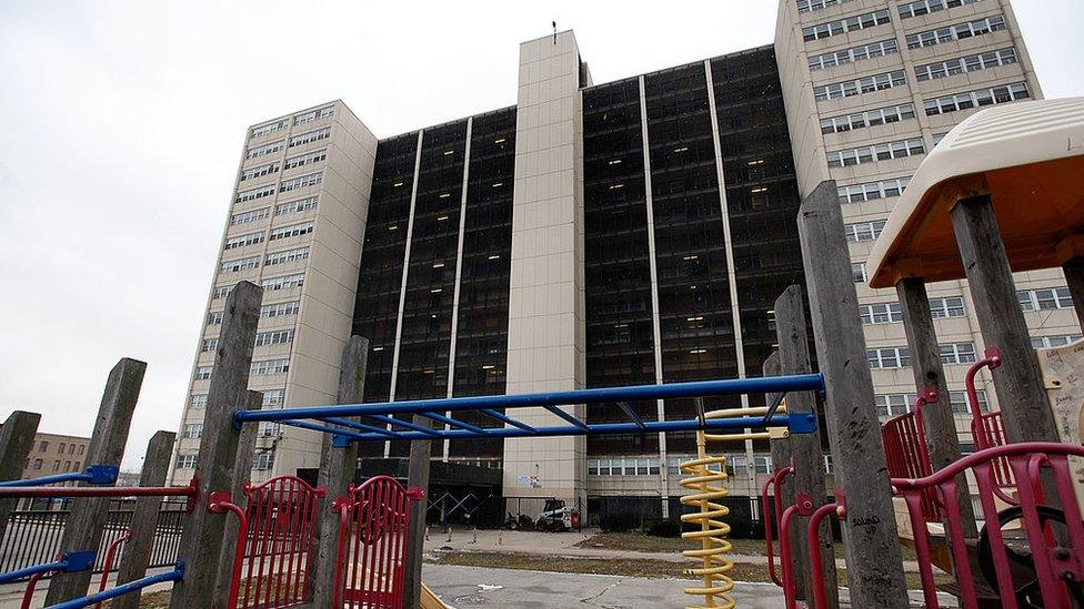 A disused children's playground outside an abandoned block of flats