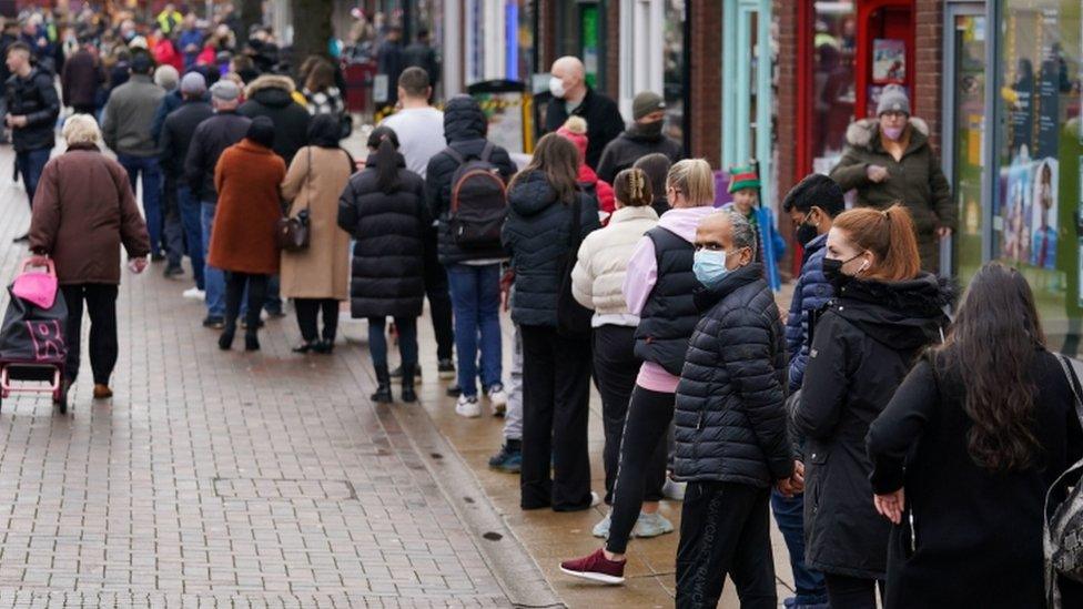 Hundreds of people queue at a vaccination centre on Solihull High Street, West Midlands