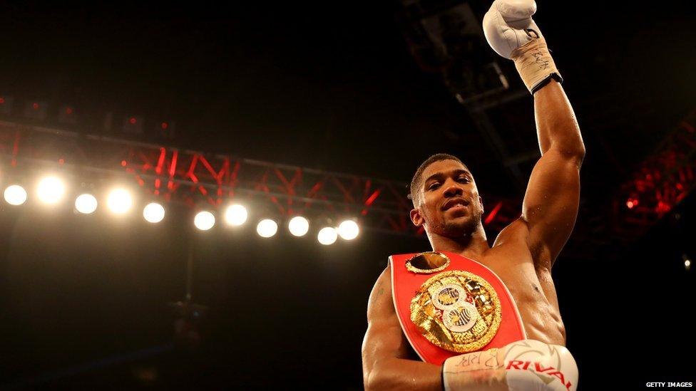 Anthony Joshua raises his arm aloft after a win