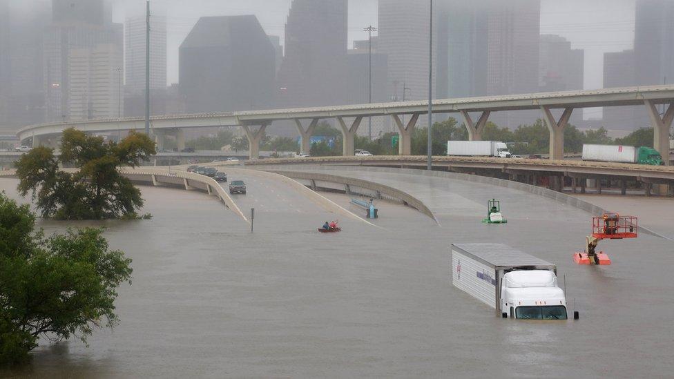 A flooded highway in Houston with a submerged lorry.