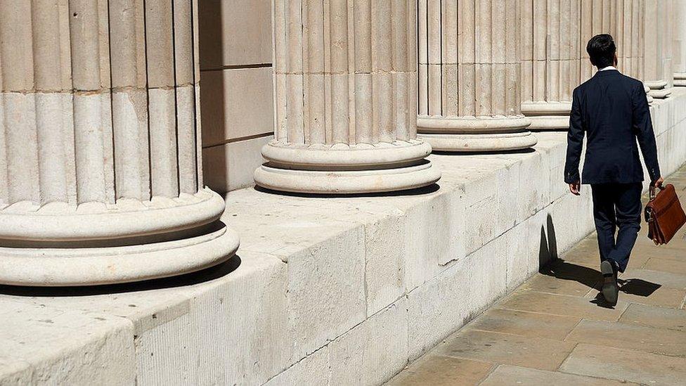 A pedestrian walks past the Bank of England (BOE) in the City of London on July 14, 2016