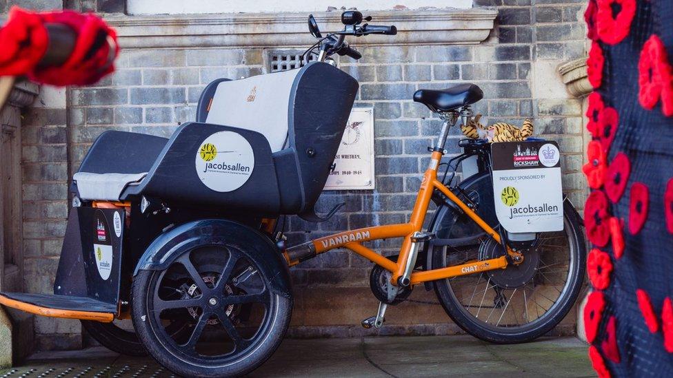 The blue and orange rickshaw bike