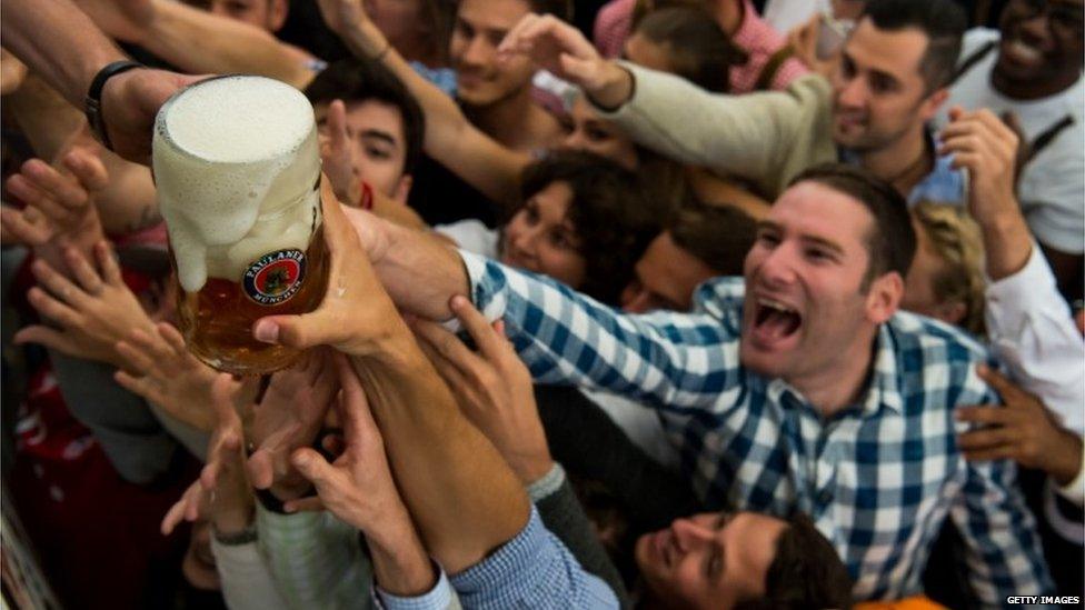 Visitors reach for one-litre glasses of free beer to kick off the 2016 Oktoberfest beer festival