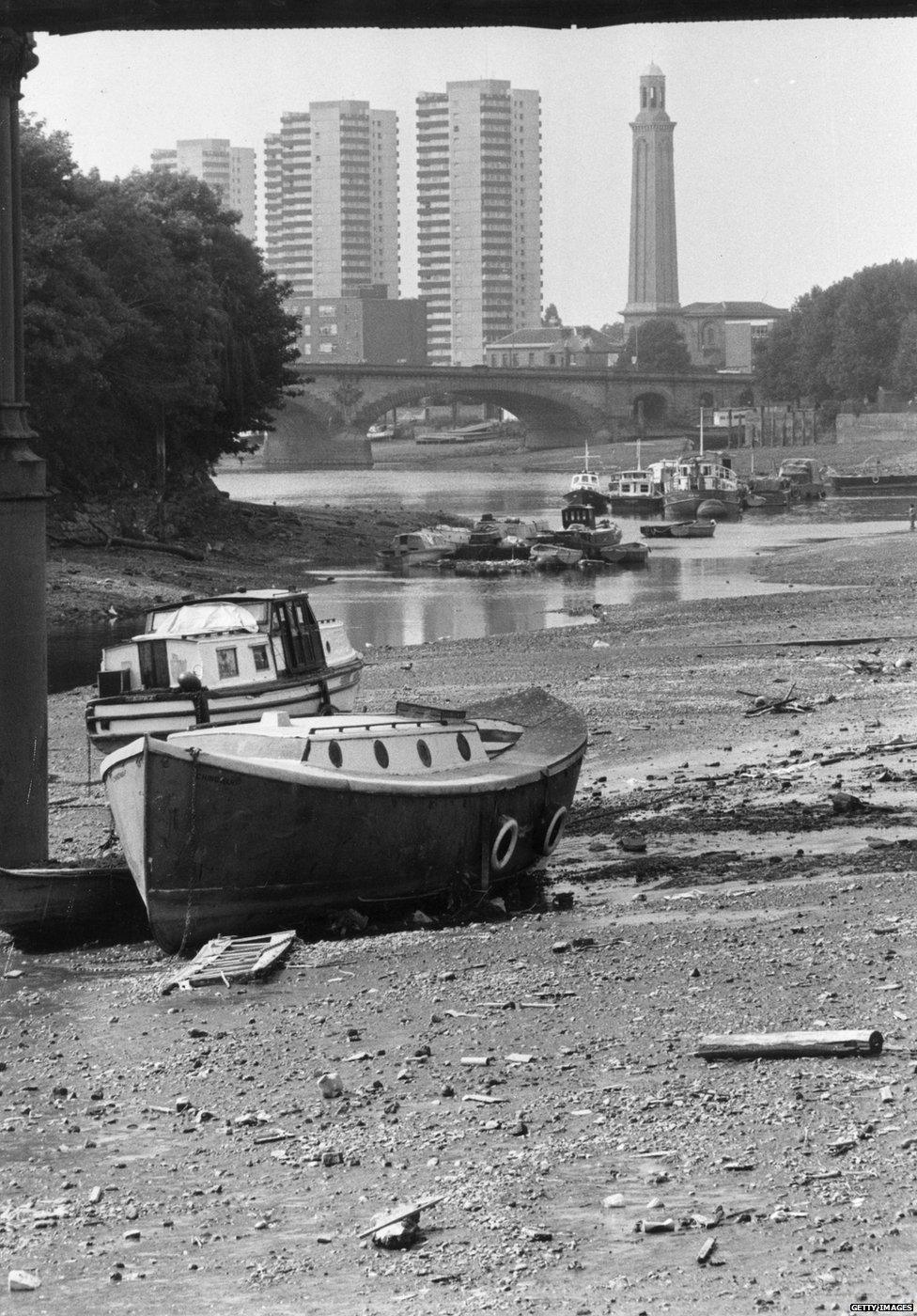 Boats are stranded on the River Thames at Strand-on-the-Green near Kew