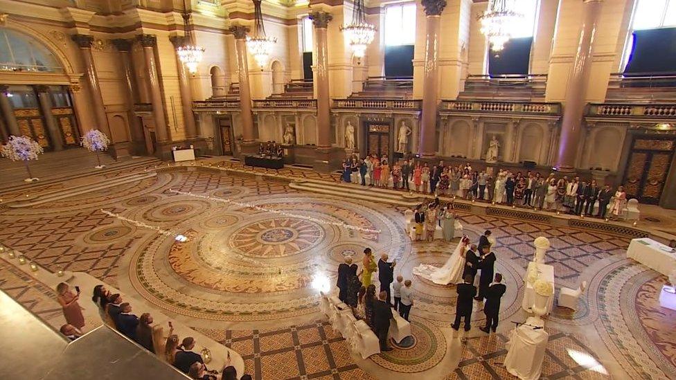 View of the wedding ceremony on the Minton tiled floor in Liverpool's St George's Hall.