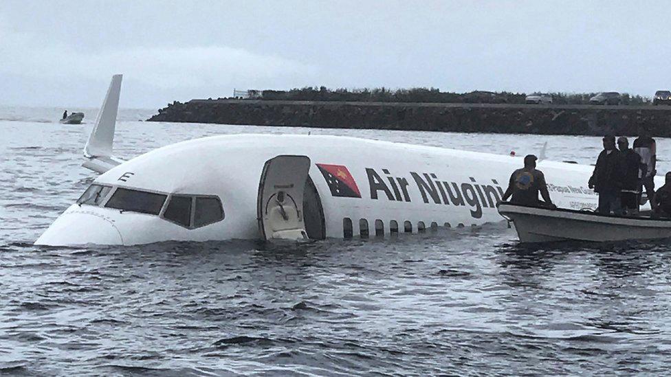 Locals approaching the crashed Air Niugini aircraft on the remote Island of Weno, in Micronesia