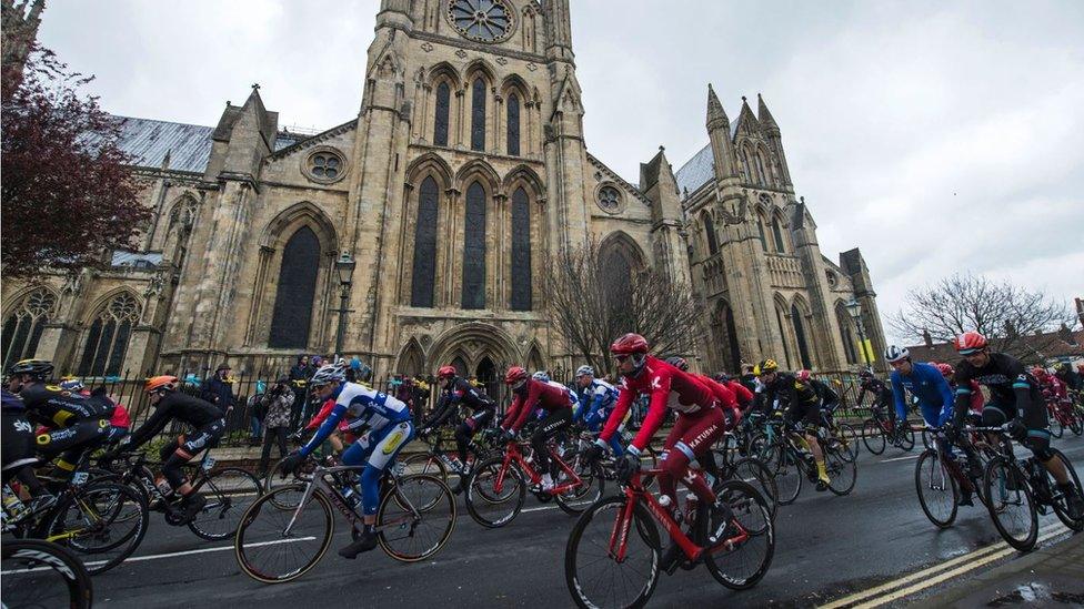 Cyclists riding past Beverley Minster