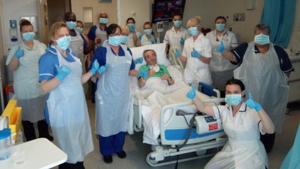 Paul in bed surrounded by medical staff