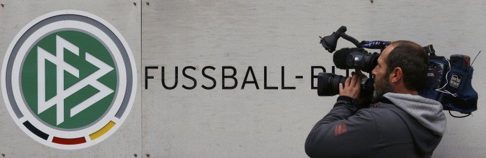 A cameraman shoots the logo at the Germany's DFB football association headquarters in Frankfurt, Germany, 3 November 2015