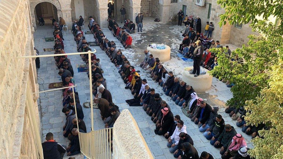 Palestinian Muslims pray at the Nabi Musa site in the West Bank on 27 December 2020