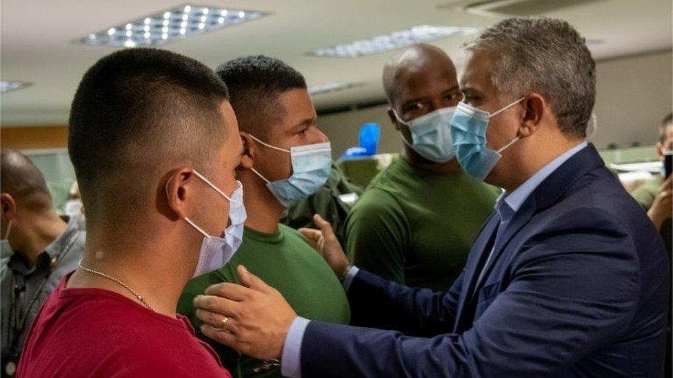 Colombia's President Ivan Duque greets police officers at the Metropolitan Police Command in Cali, Colombia, May 28, 2021.