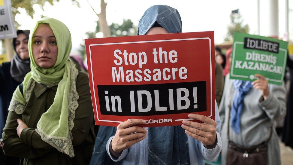 Turkish women hold of posters and chant slogans against the possible Syrian government offensive on Idlib province, at a protest in Istanbul (7 September 2018)