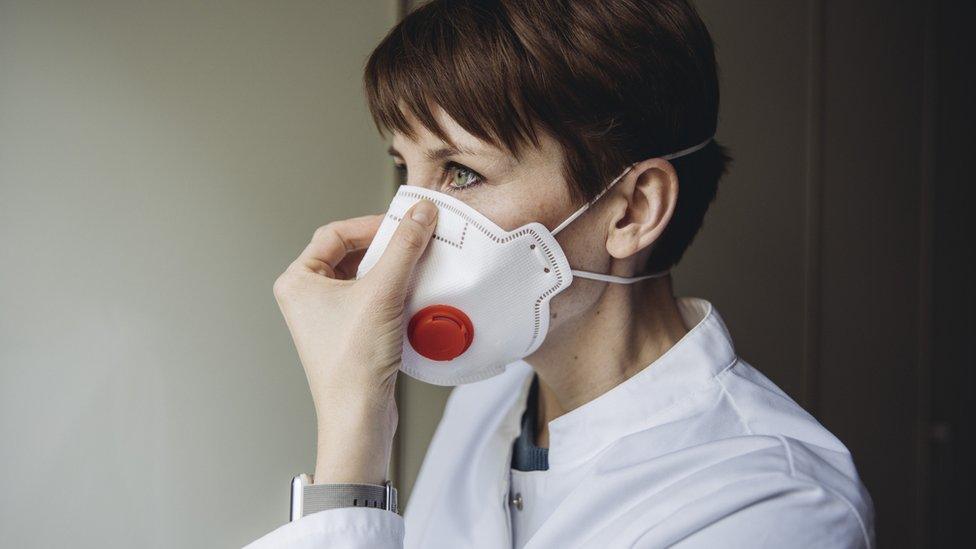 A woman wearing an FFP3 mask