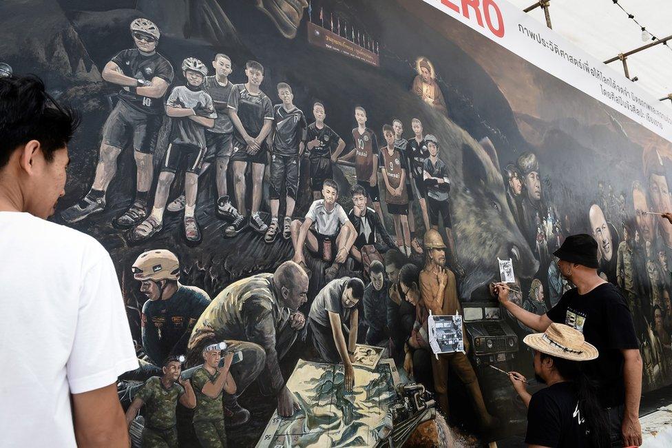 Artists work on an art mural at Art Bridge gallery in Chiang Rai, Thailand