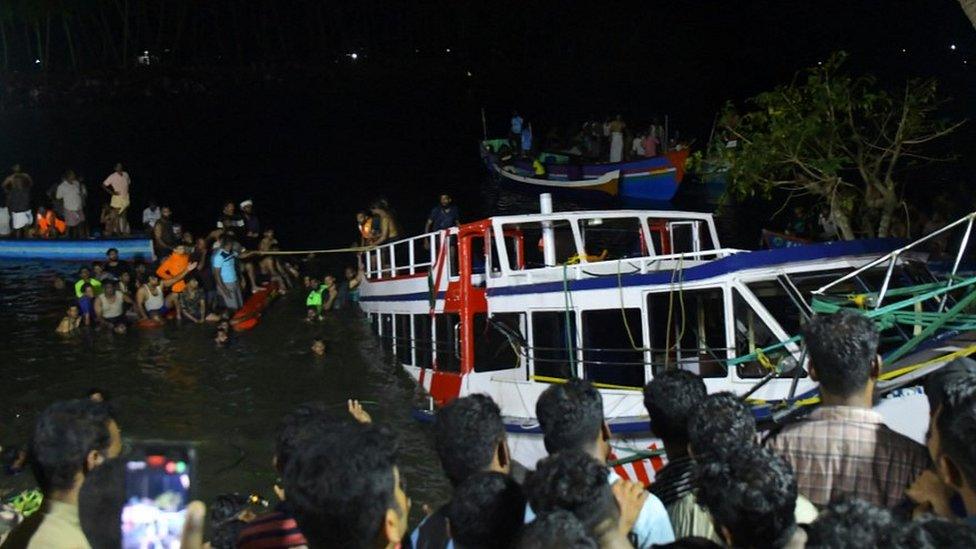 Rescuers search for survivors from the wreckage of a boat in India's Kerala state, 8 May 23