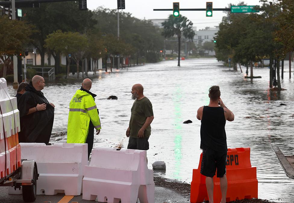 Police man a roadblock to keep cars from driving through flood waters from Hurricane Idalia on August 30, 2023 in Tarpon Springs, Florida