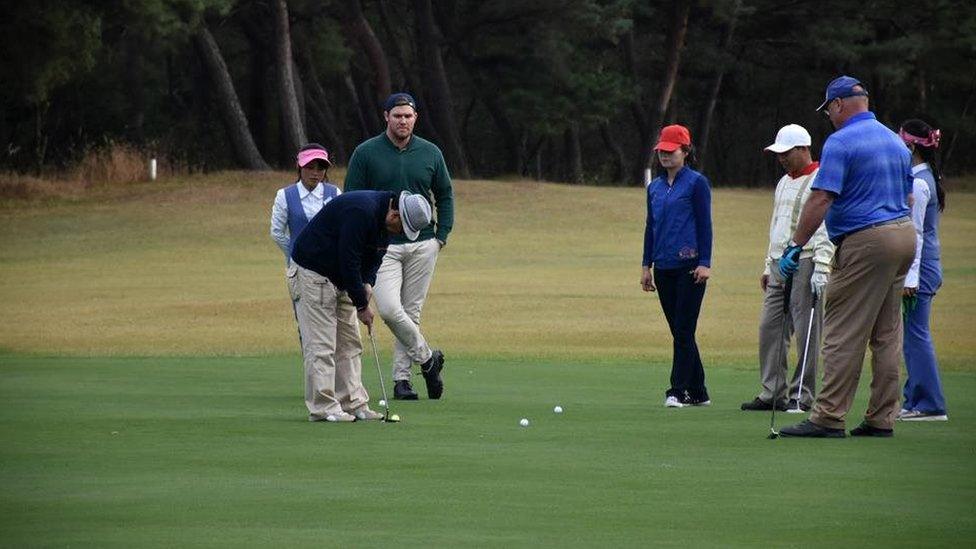 Mr Ruig watches a fellow competitor on the putting green