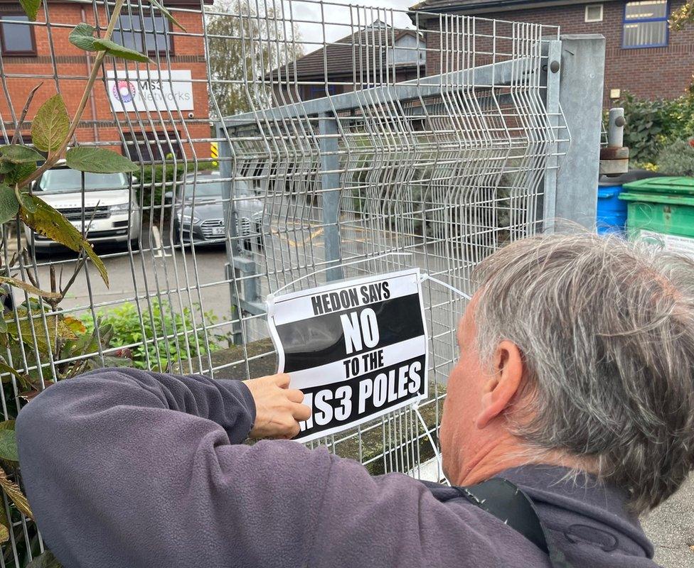 A campaigner puts up a sign outside MS3 Networks' offices in Hessle