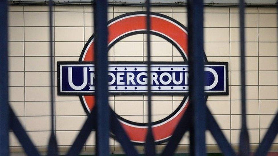 London Underground sign behind closed gates