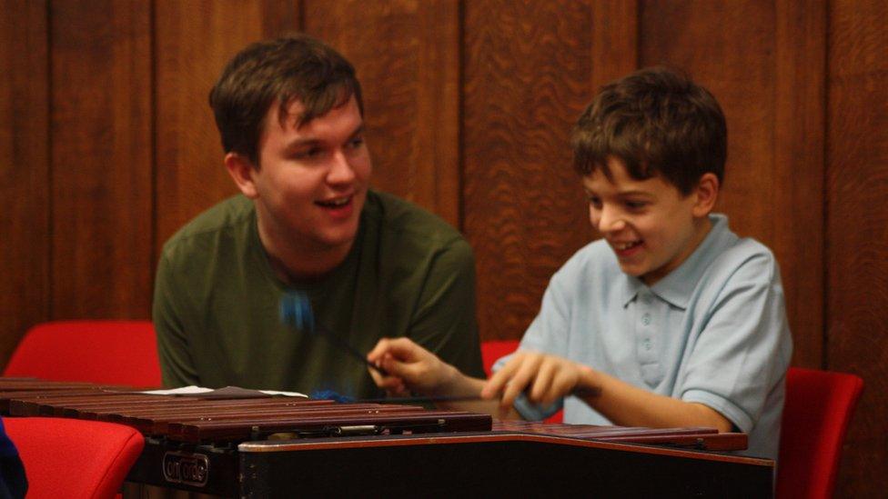 A child being taught music during the Turtle Opera project